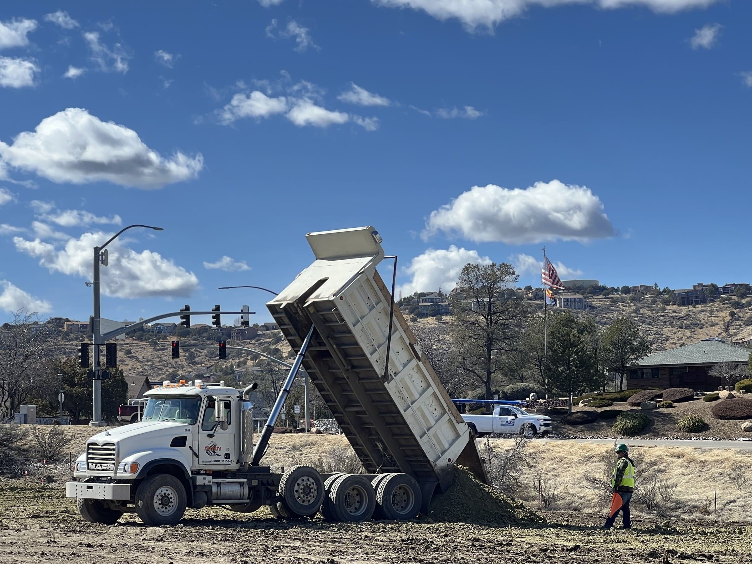 A dump truck on a commercial site.